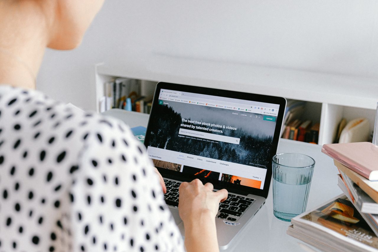 A woman working from home on a laptop, illustrating a freelance lifestyle.